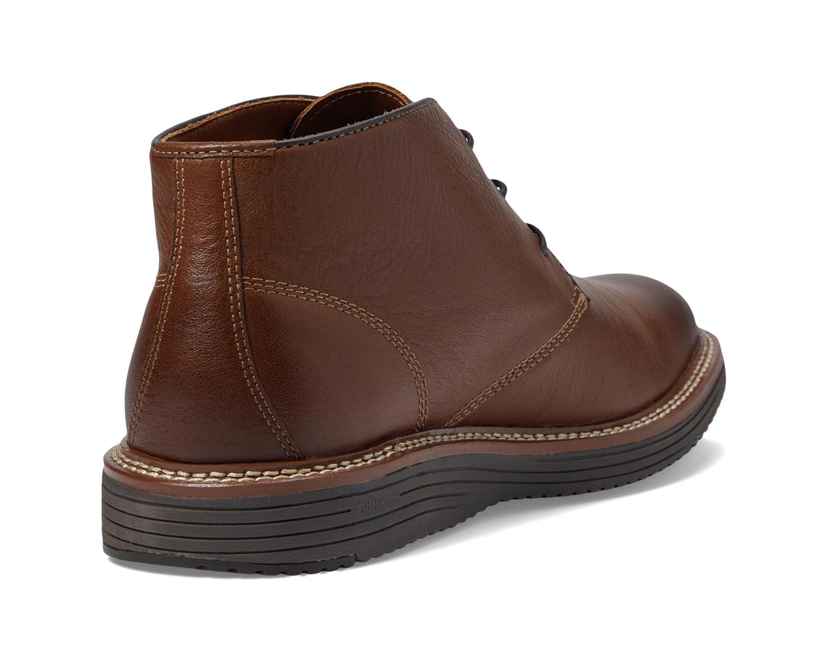 Tan leather chukka boots viewed from the heel, showing side seam and sole tread.