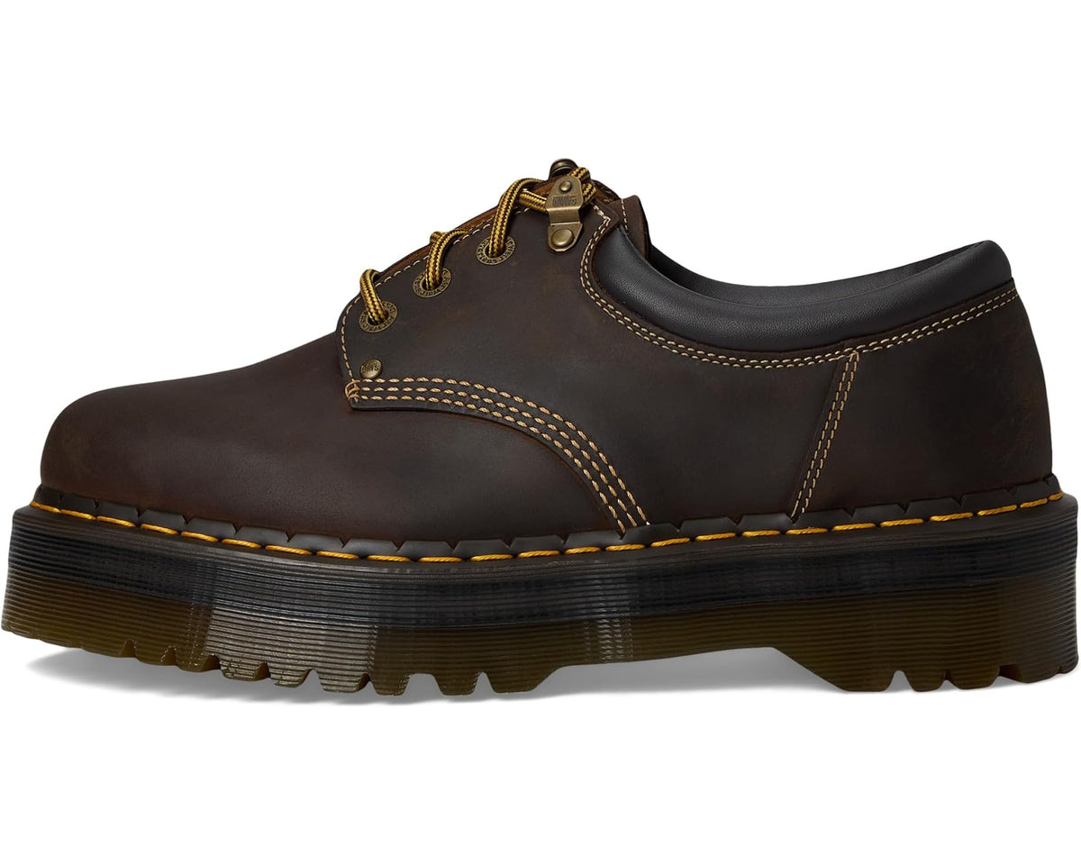 Dark brown leather lace-up shoe with yellow edge stitching and platform sole