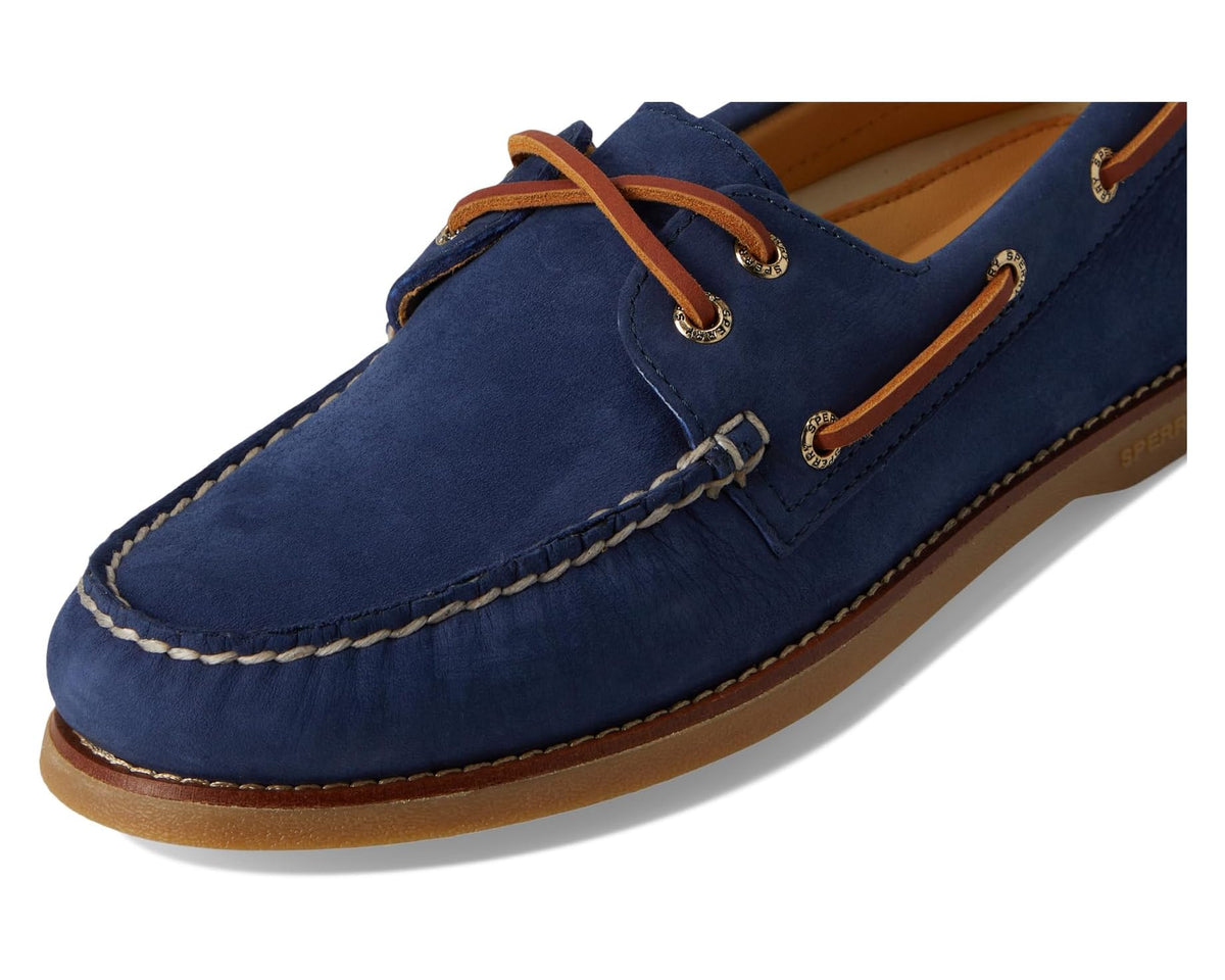 Navy suede boat shoe close-up with tan lace loops and contrast welt stitching