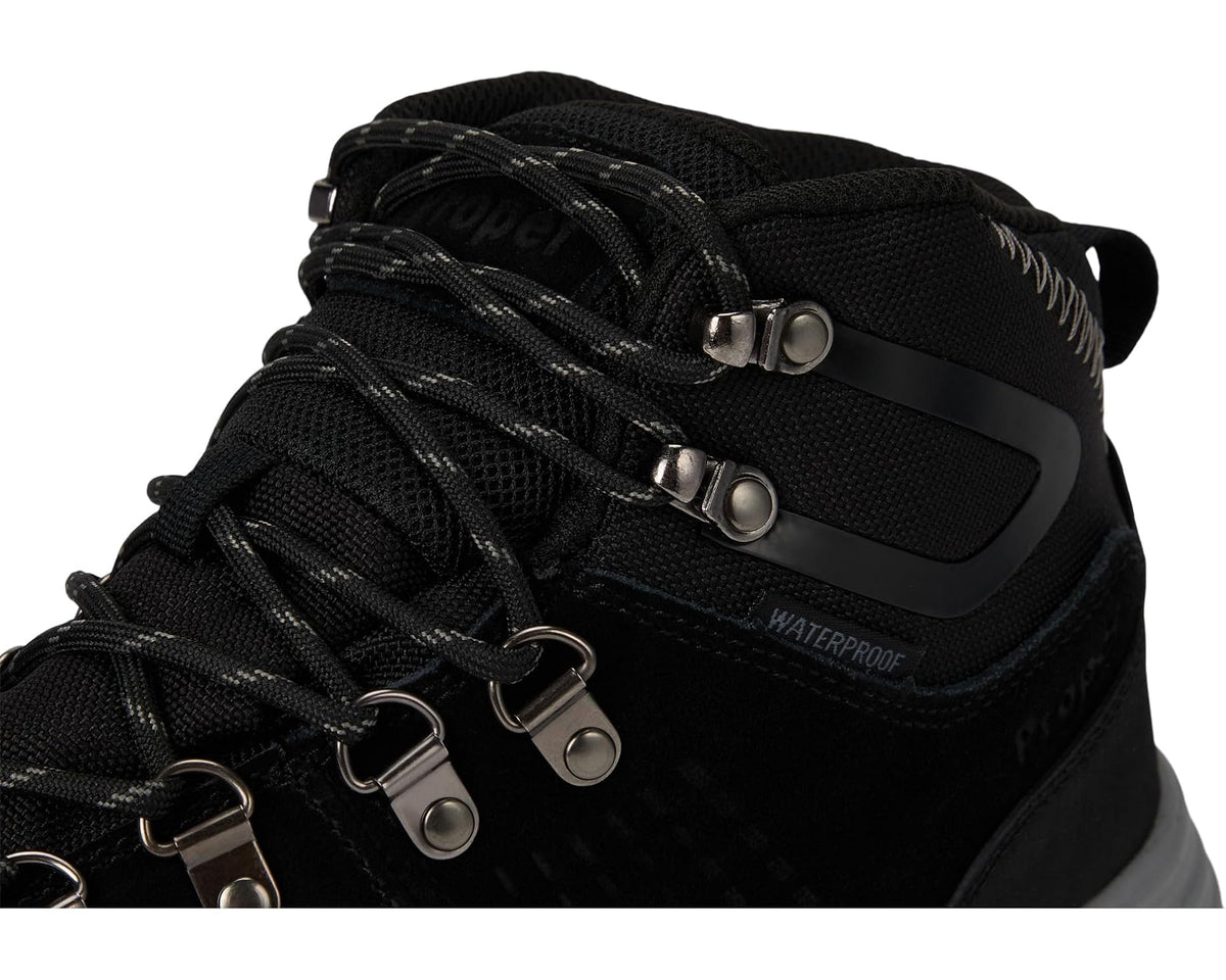 Black lace-up boot with 'WATERPROOF' label and dual hook-and-loop straps