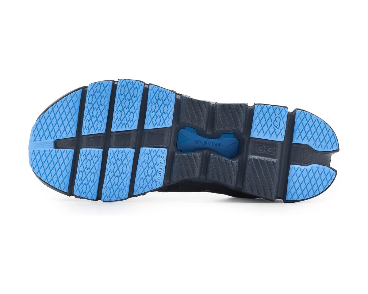 Blue-and-black rubber outsole with grippy tread pods and raised traction channels
