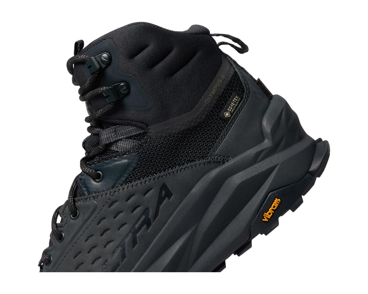 Men's black hiking boot upper close-up with lace panel and cushioned collar