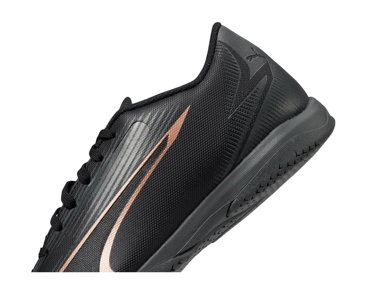 Men's PUMA indoor training shoes, close-up black upper with copper rose logo stripe