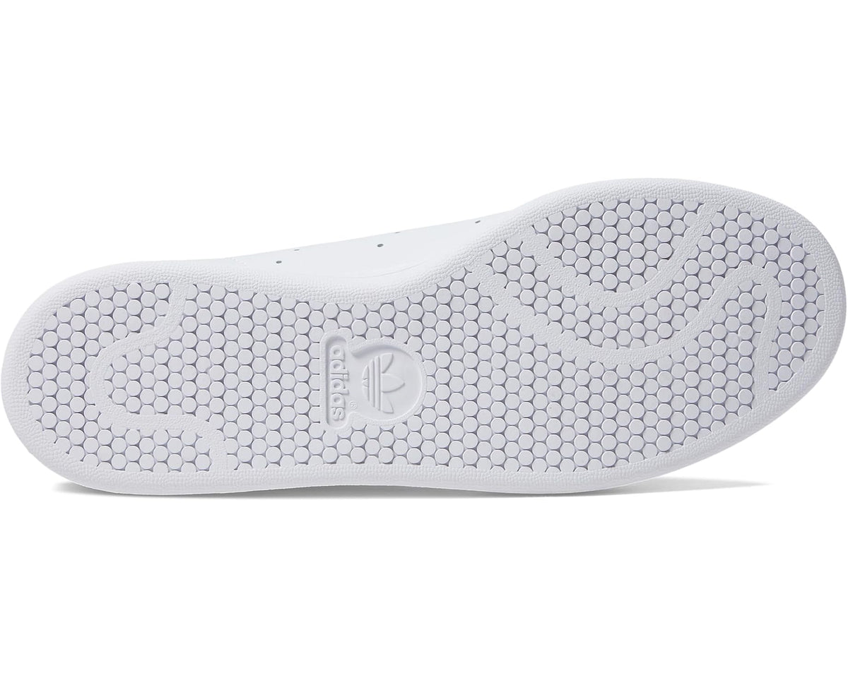 White rubber outsole with hex-pattern tread and adidas logo