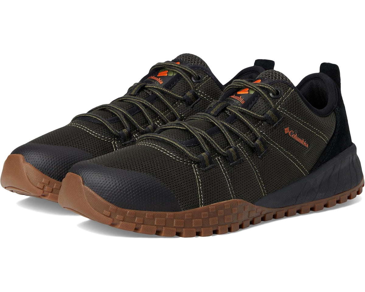 Men's low-top hiking shoe in dark olive with orange lace accents and brown tread sole