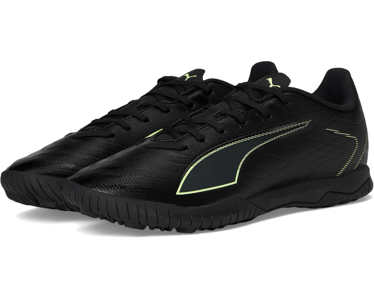 Black PUMA turf soccer cleats with neon green accents, lace-up