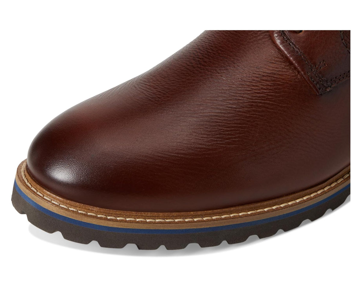 Brown tumbled leather upper close-up with stitching details and lace-eyelet area