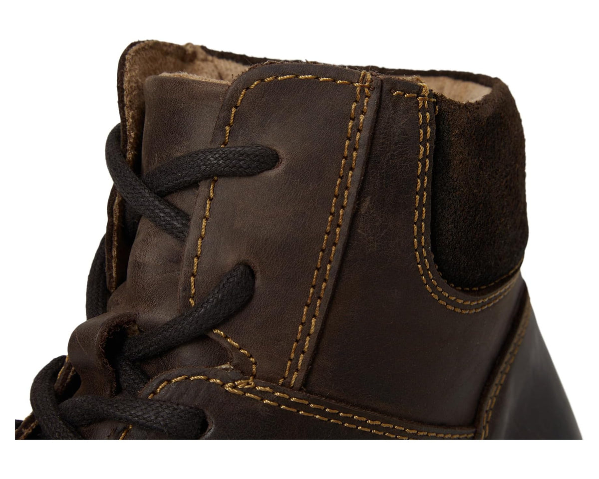 Close-up of brown lace-up ankle boot showing laces, eyelets, and inner lining