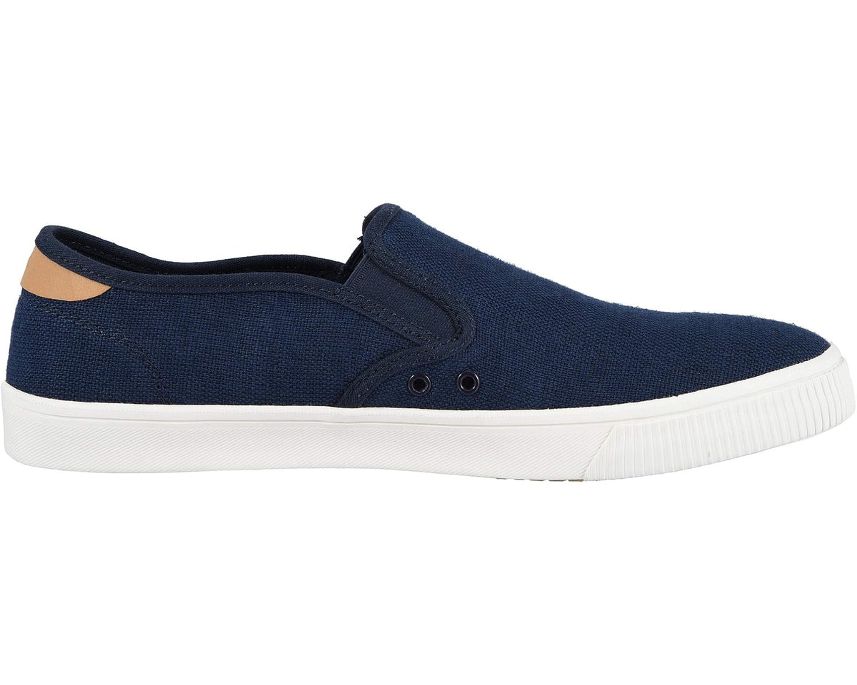 Men's TOMS navy canvas slip-on sneaker side view with eyelets and white sole