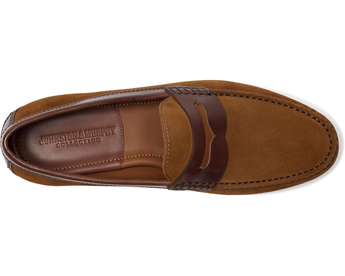 Brown suede penny loafer profile with leather keeper strap and stitched apron