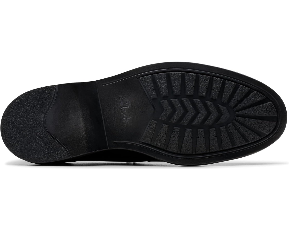 Black leather loafer outsole with textured tread and arrow pattern