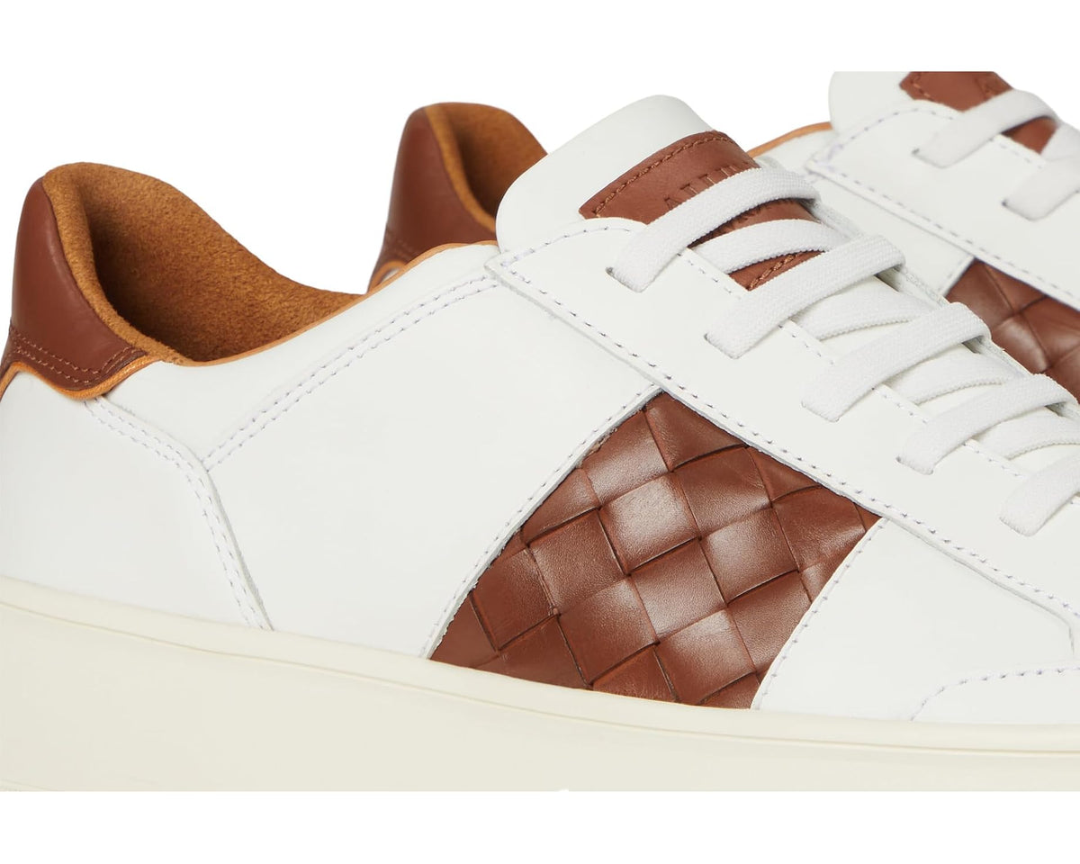 Close-up white leather sneaker with woven brown diamond-pattern side panel