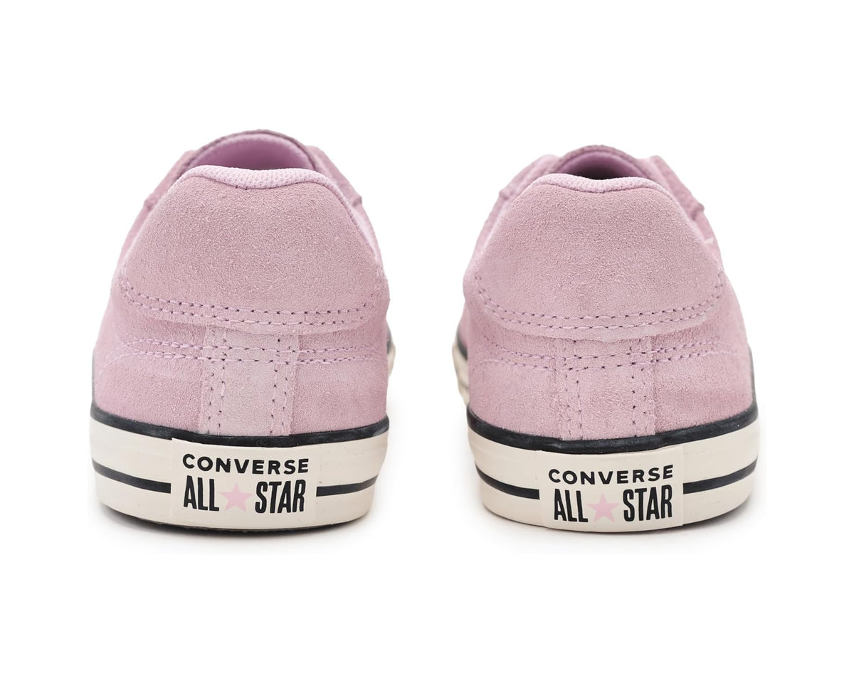 Back view of pink suede low-top sneakers with Converse All Star heel stripe