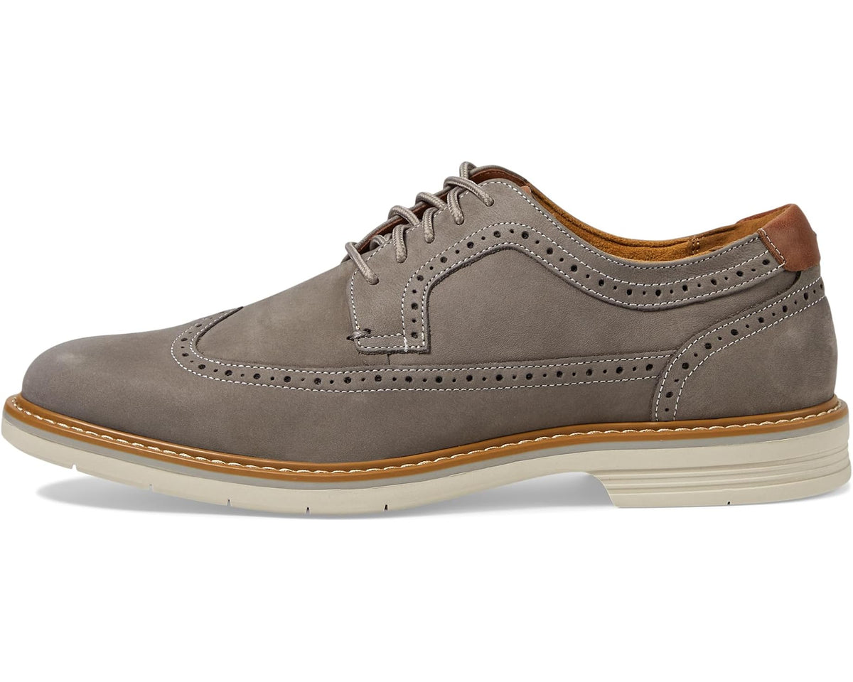 Gray nubuck wingtip oxford with contrast welt, lace-up closure, and brogue detailing.