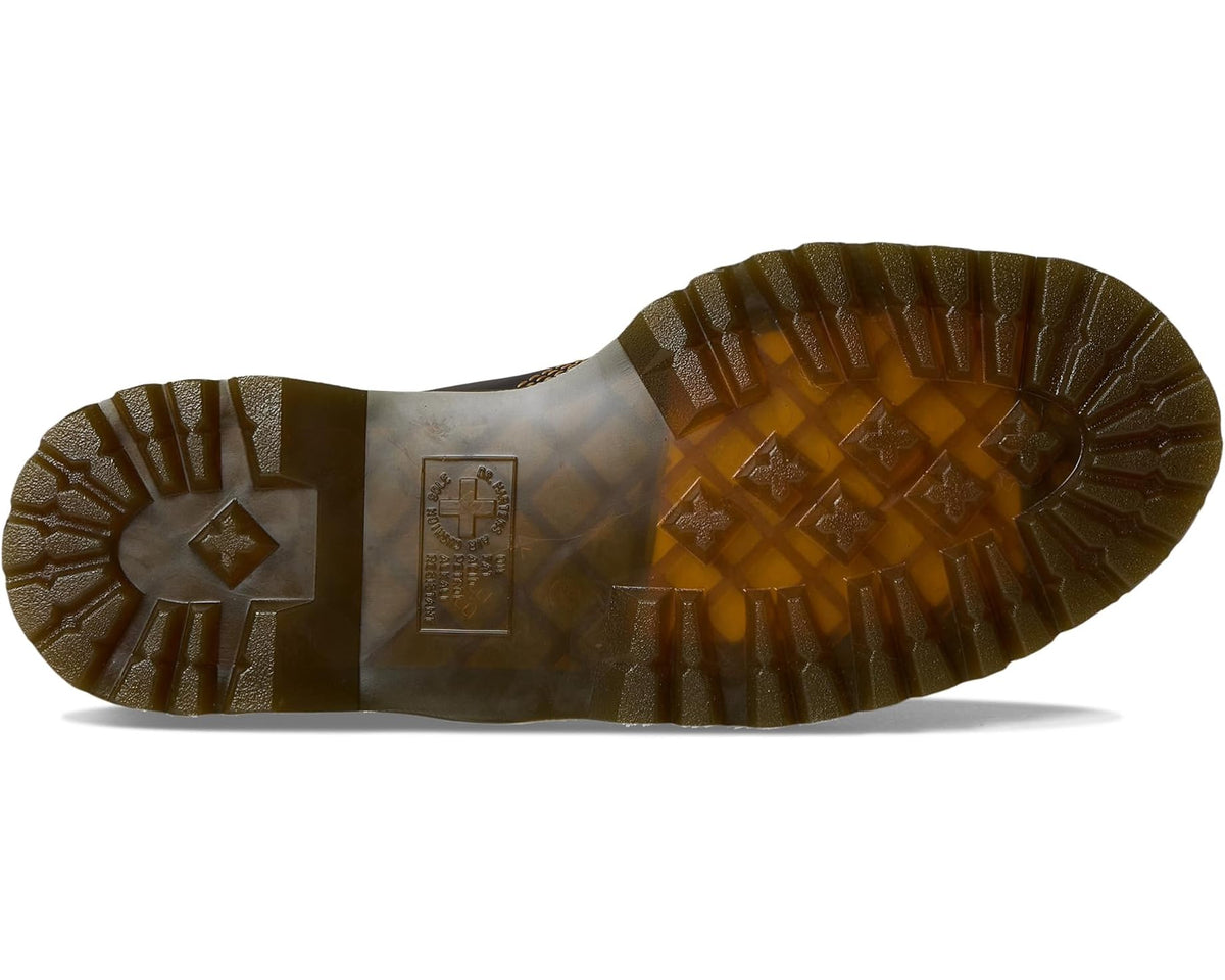 Dark brown shoe outsole with deep tread pattern and heel label patch