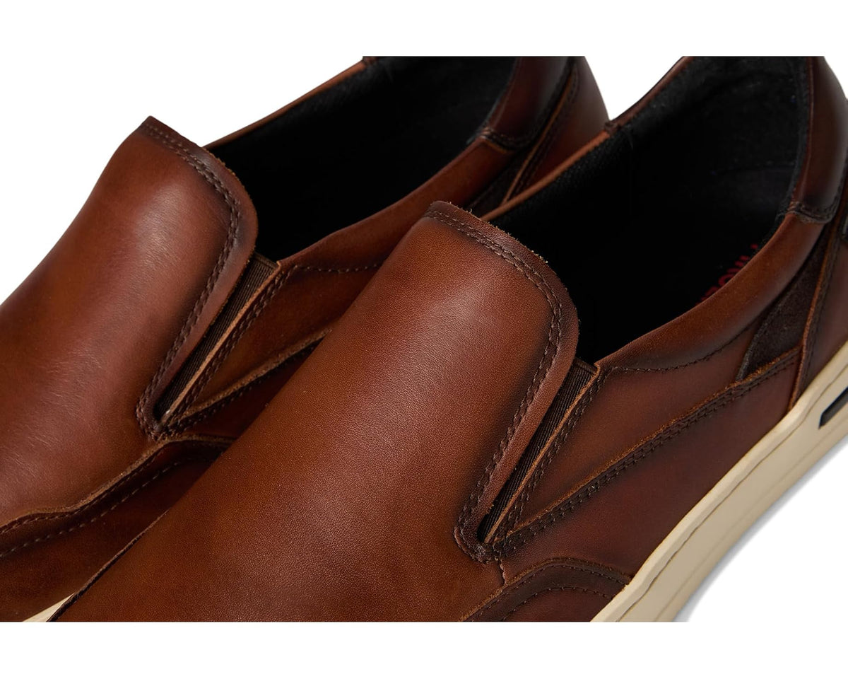 Close-up of brown leather slip-on upper with stitched seams and padded instep