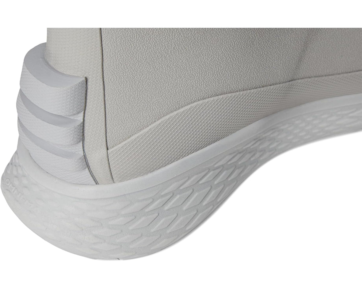 Close-up of light grey boot upper and white cushioned midsole tread