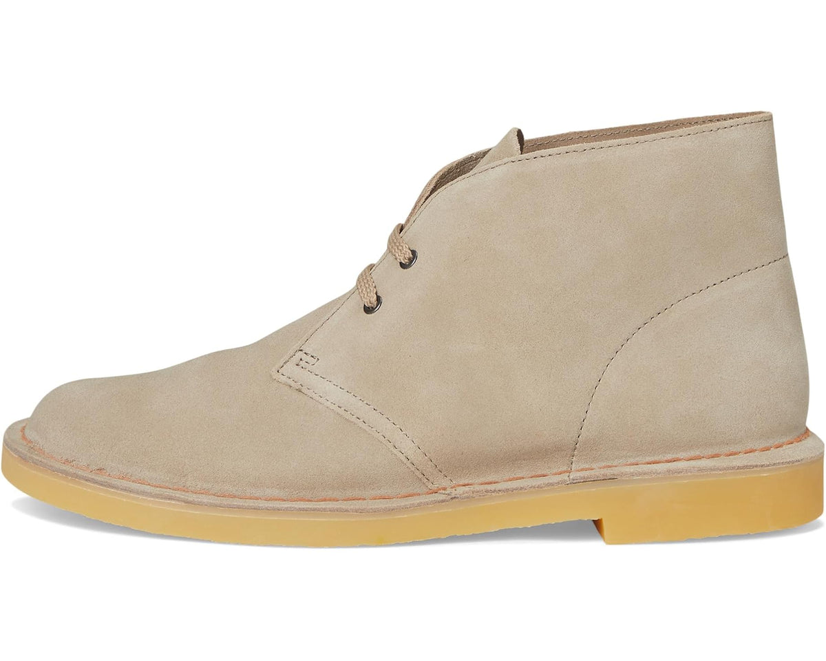 Sand suede lace-up chukka boot with stitched panels and chunky yellow outsole.