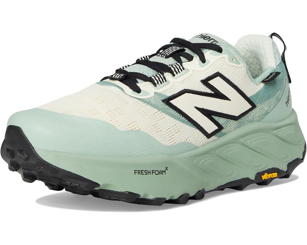 Men's New Balance trail shoes, angled front view in mint and cream with black N