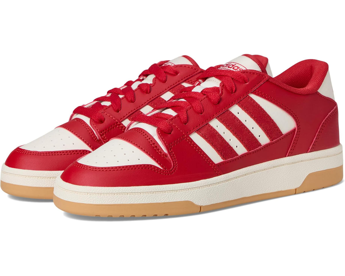 Red and white adidas low-top sneakers with three stripe panels and lace-up closure.