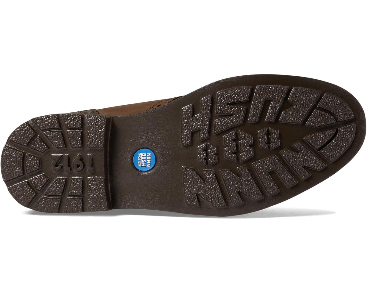 Brown chukka boot outsole with rugged tread and blue logo badge
