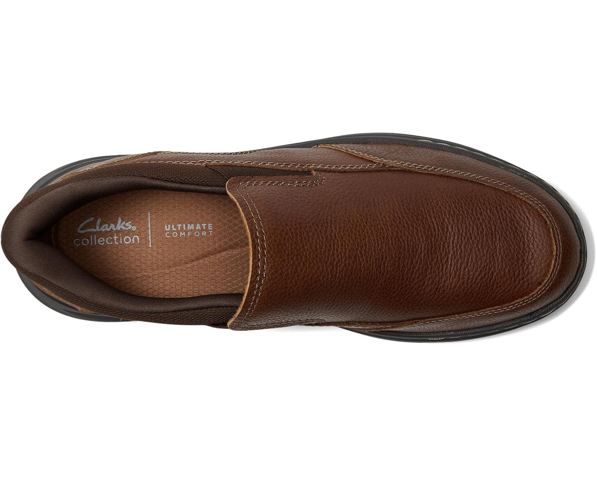 Brown leather slip-on shoe, rounded toe, stitched upper and dark interior lining
