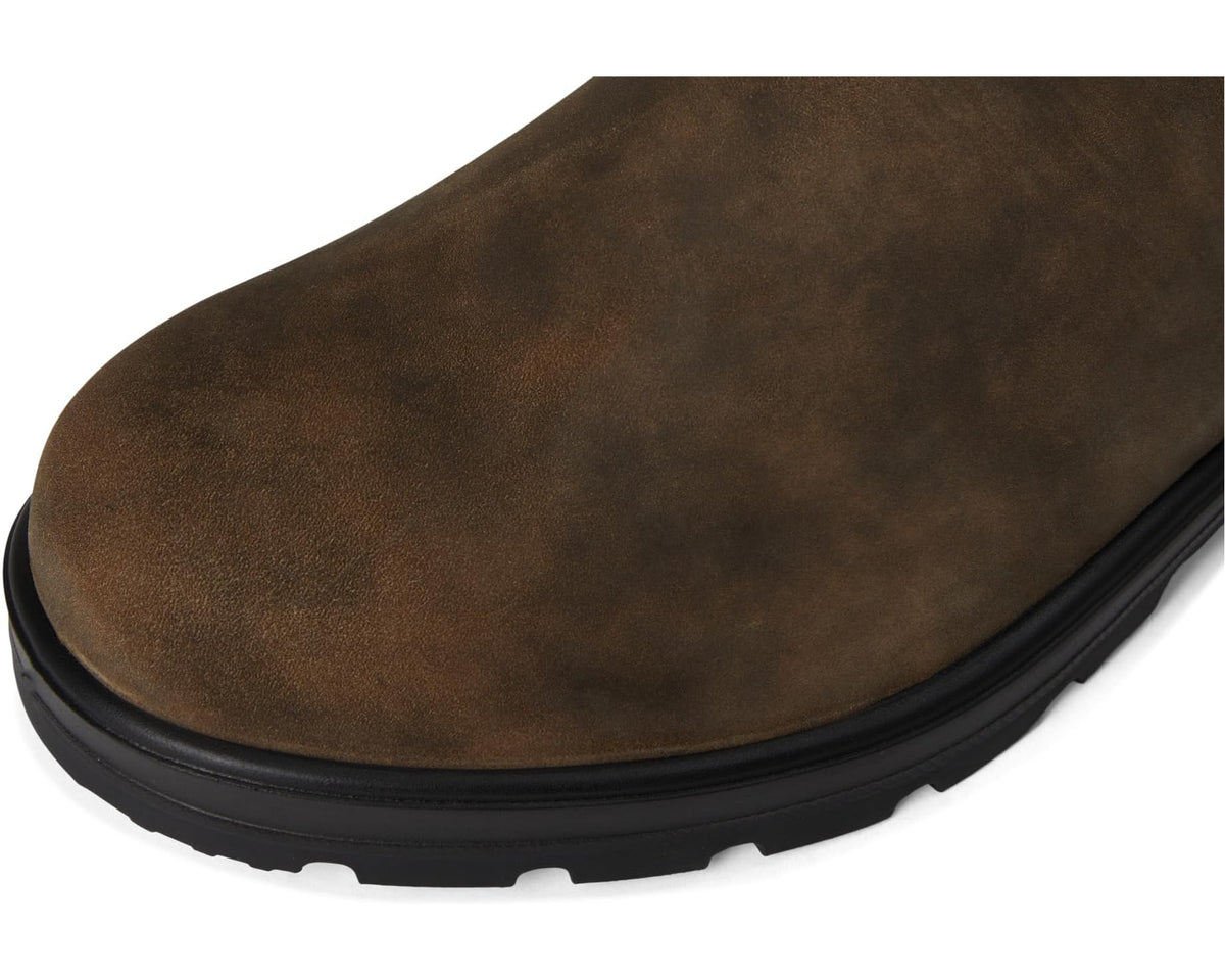 Rustic brown suede chelsea boot toe with rounded shape and black rubber outsole