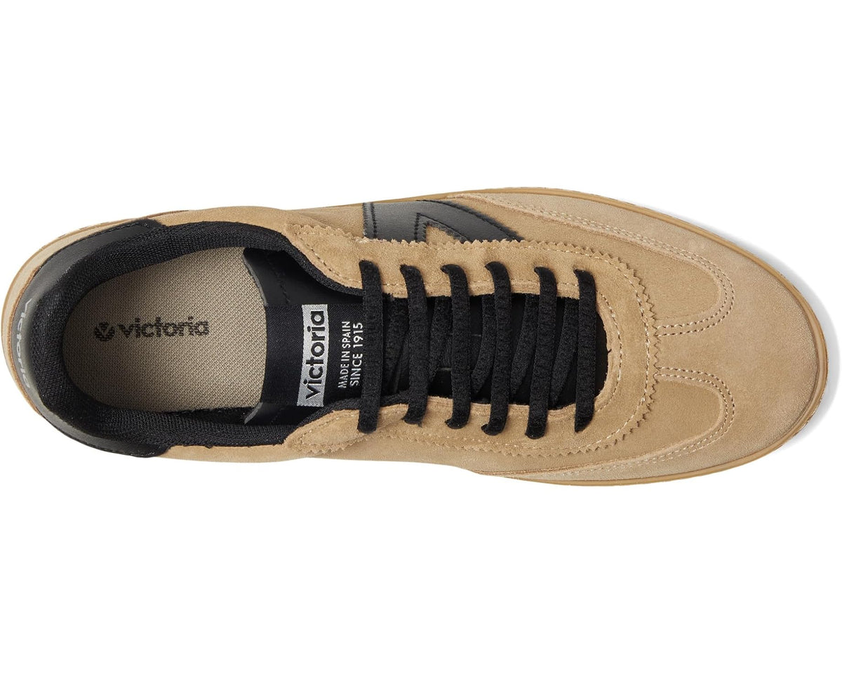 Beige sneaker interior view with black laces and logo tongue label