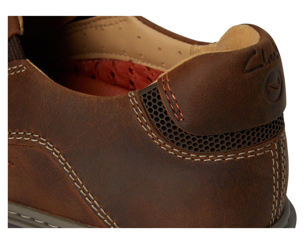 Men's brown leather slip-on loafer upper detail with mesh panel and stitching