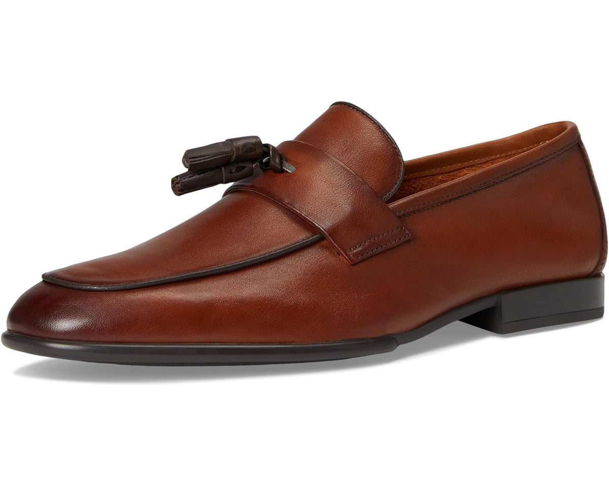 Tan leather loafer with tassel detail, moc toe stitching, and dark outsole