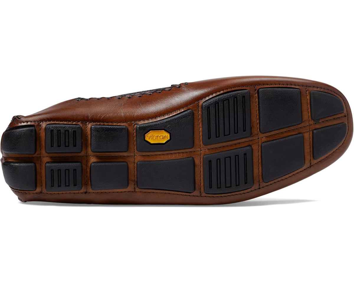 Brown leather loafer outsole with grid traction tread and dark rubber pads
