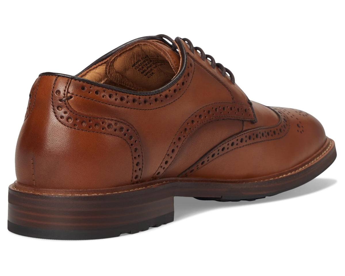 Men's saddle tan wingtip oxford with lace-up closure and cushioned padded collar