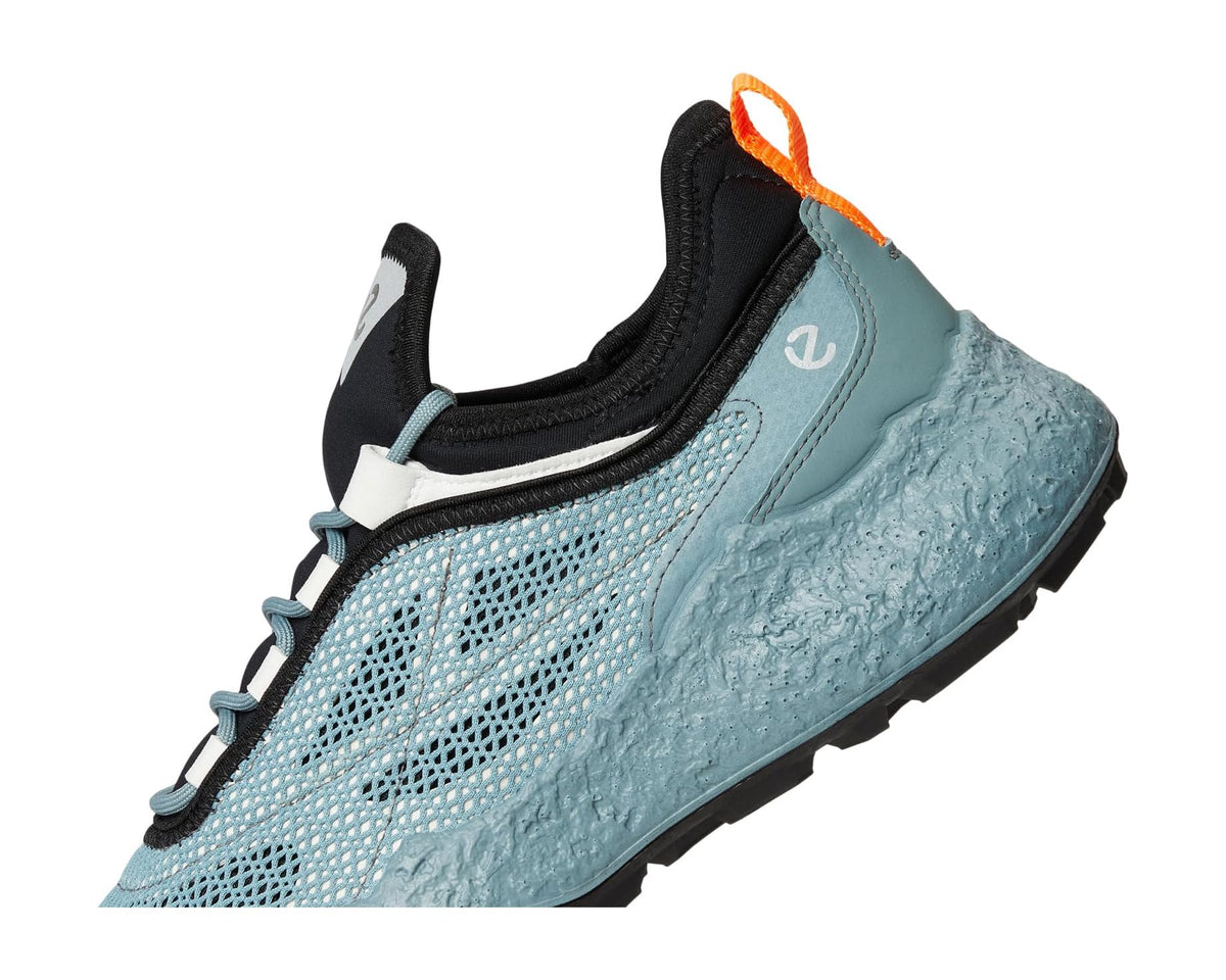Sky-blue mesh golf shoe side view with black heel collar, teal laces, and orange loop