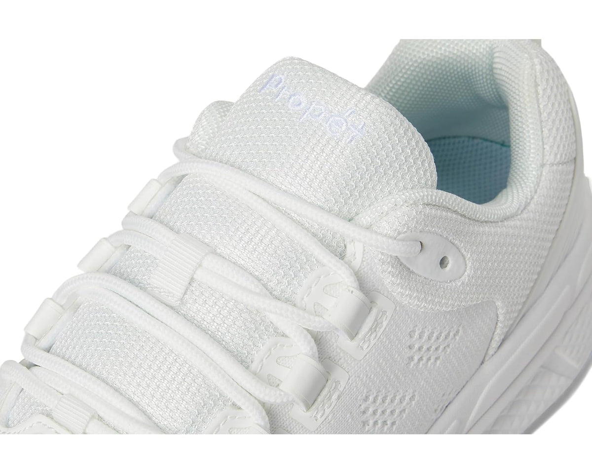 Close-up of white knit upper with lace eyelets, padded tongue, and mint lining