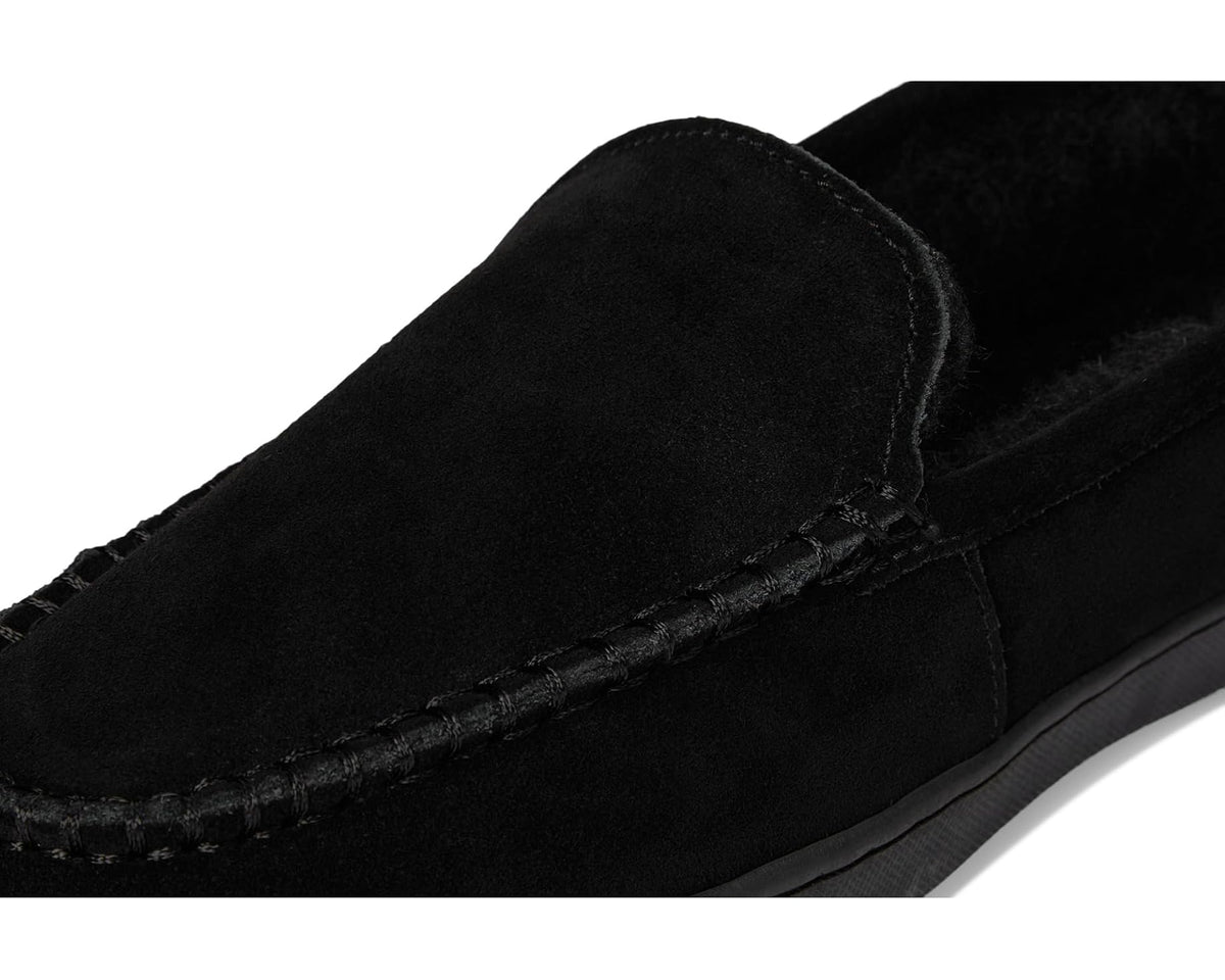 Men's black suede slip-on loafer close-up of stitched seam and moc toe