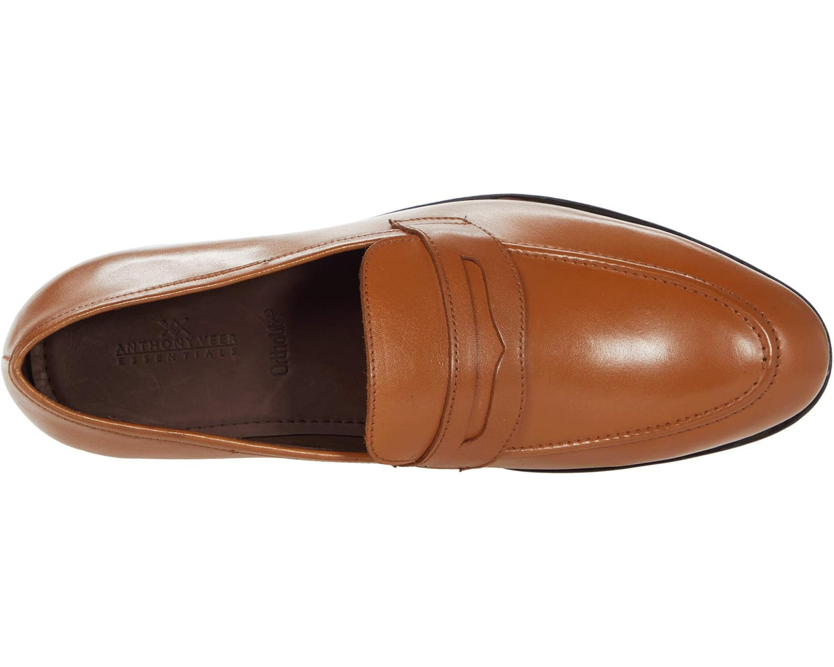 Tan leather penny loafer side view with seam stitching and moc-toe shape