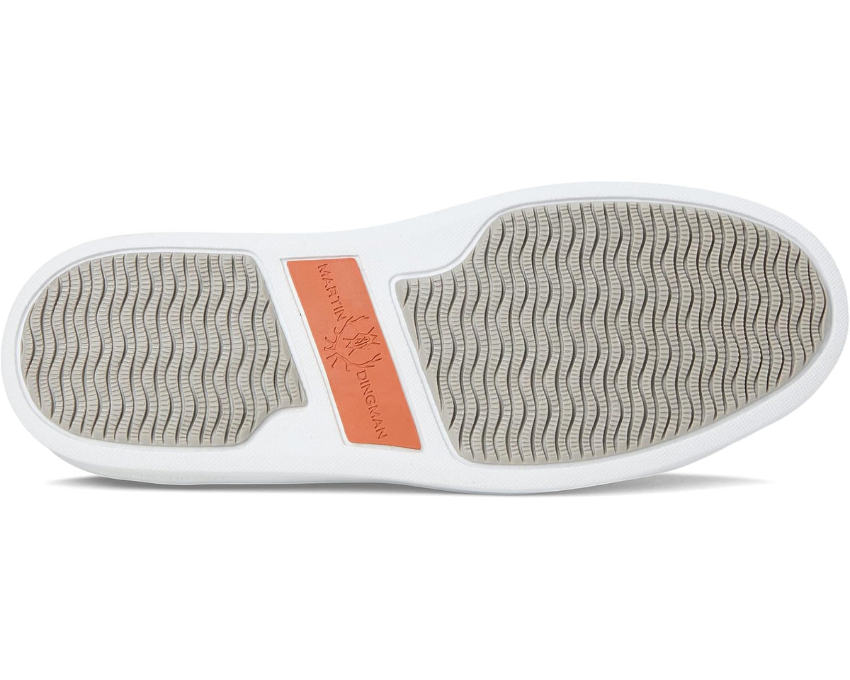 Walnut brown suede sneaker outsole with textured tread and central orange brand patch.