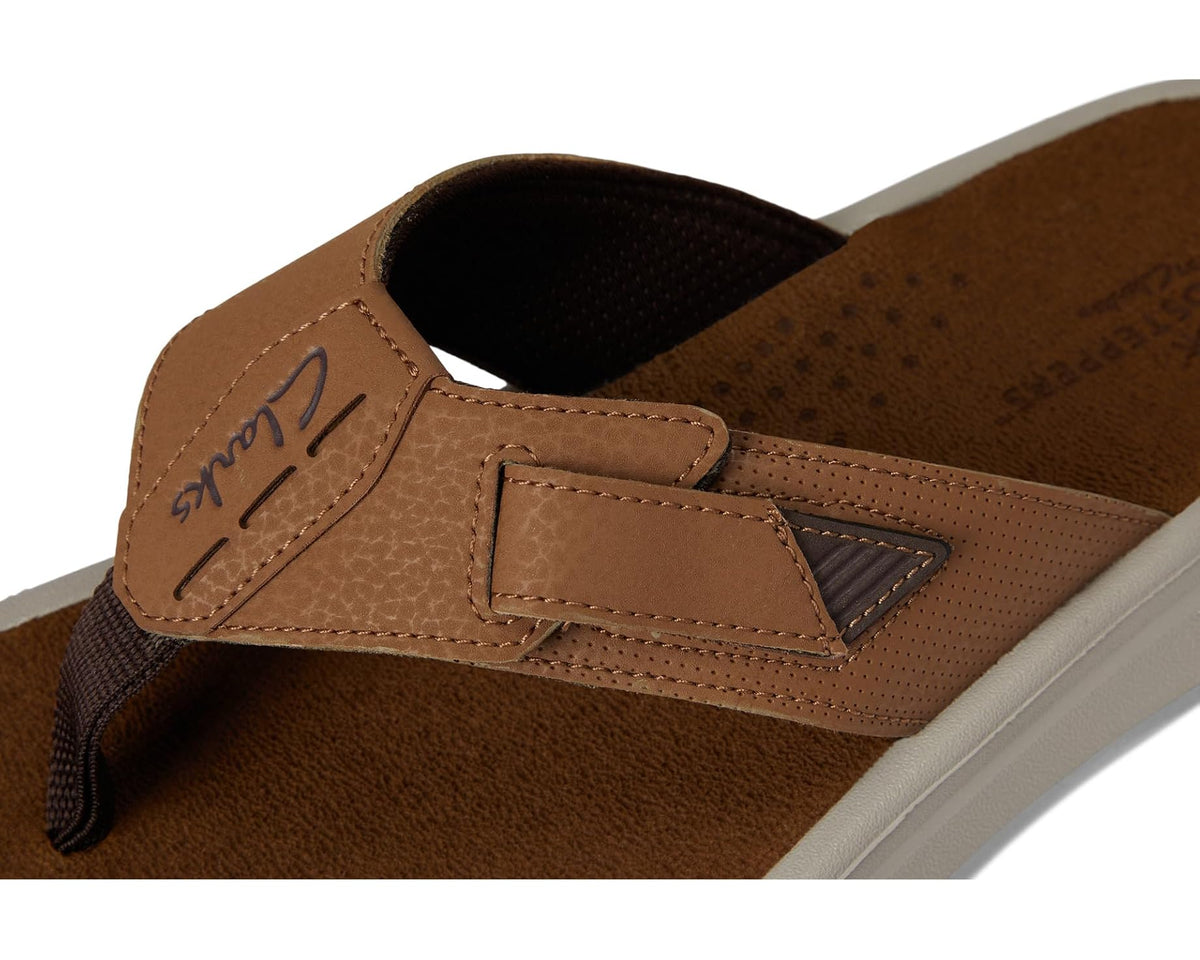 Close-up of brown synthetic sandal strap with stitched detail and Clarks logo