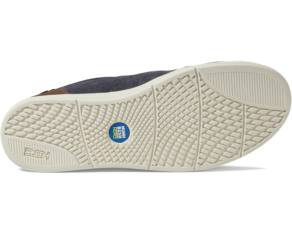 Dark blue canvas slip-on shoe with textured light sole tread and branded insole