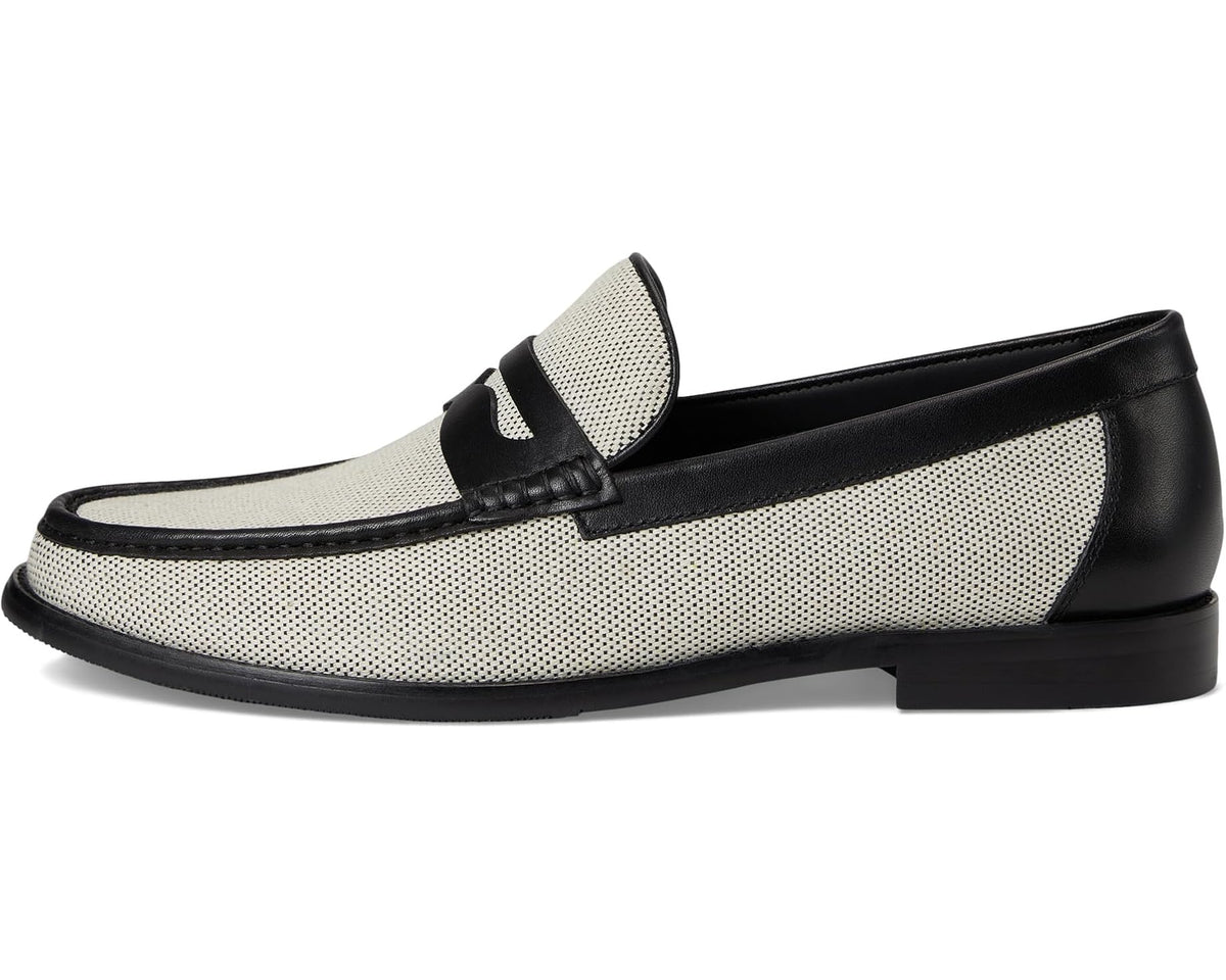 Two-tone men's loafer profile; beige perforated upper with black strap detail