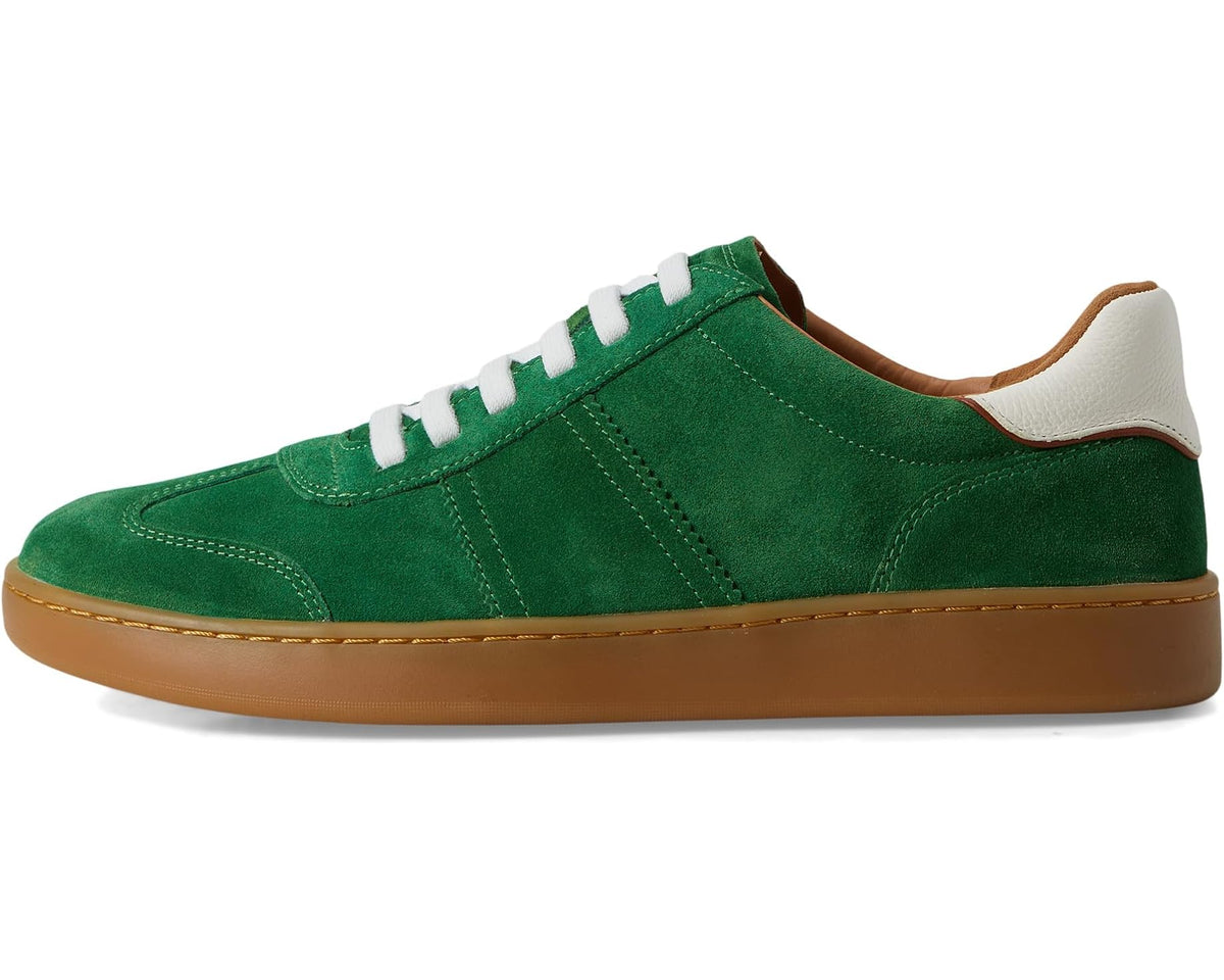Green suede low-top sneaker with white laces, tan sole, and padded collar.
