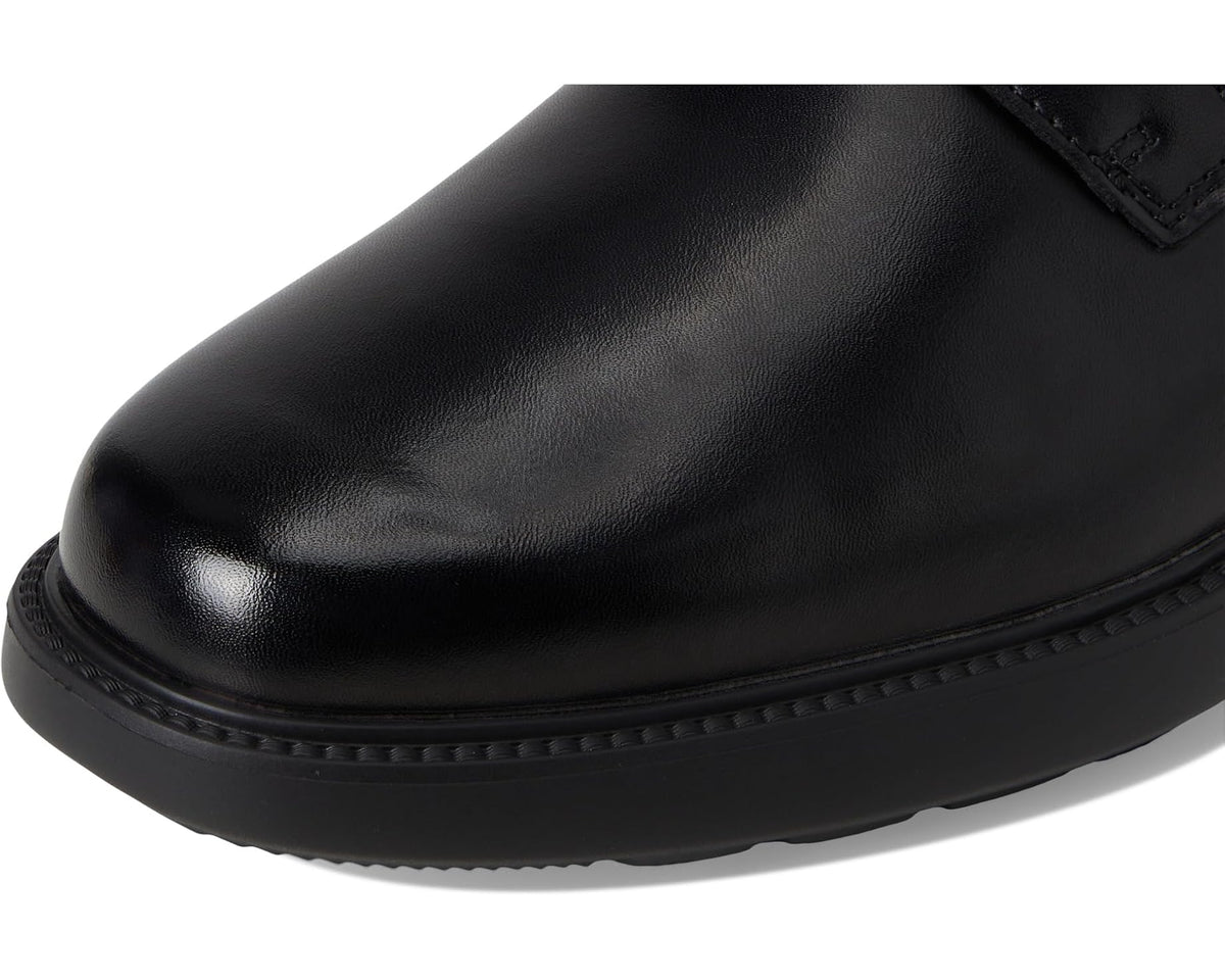 Black leather oxford shoe toe and front edge with textured welt and stitching