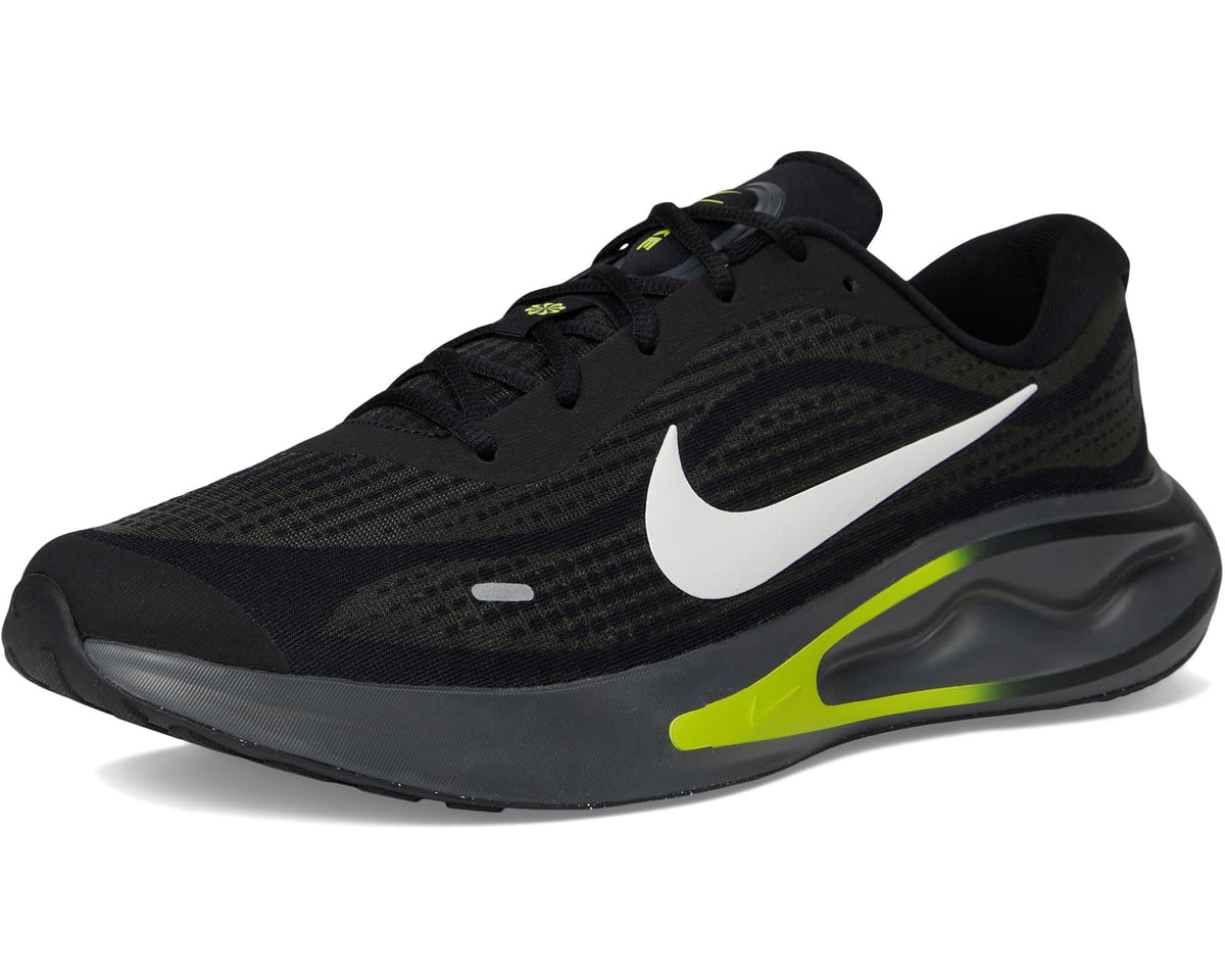 Black men's running sneaker with white swoosh and neon green side stripe