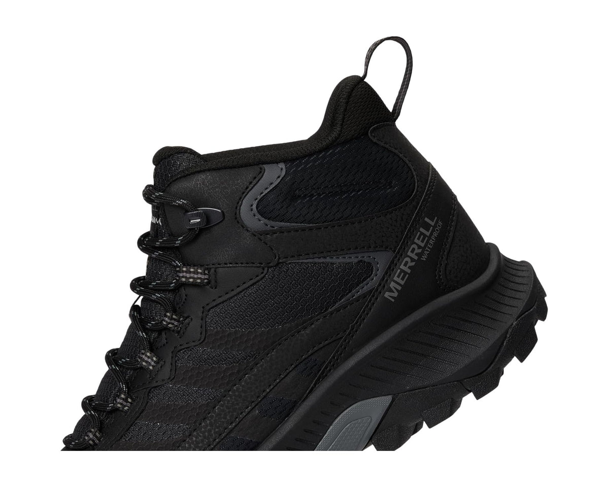Merrell black mid-top hiking boot quarter view with lace-up eyelets and logo