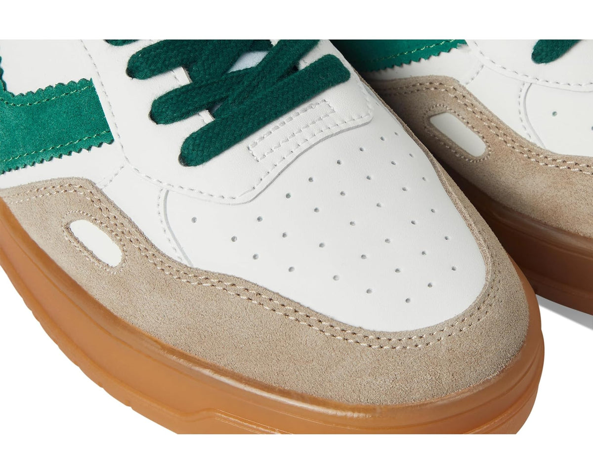 Close-up of white and green low-top sneakers with perforations and suede trim