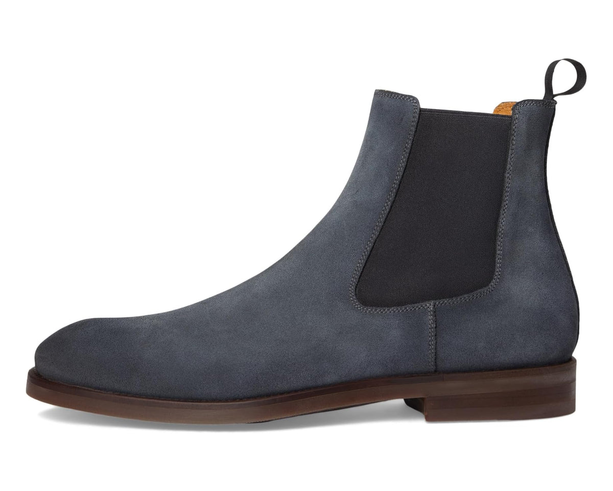 Indigo suede Chelsea boot in side view with elastic gore and brown leather sole.