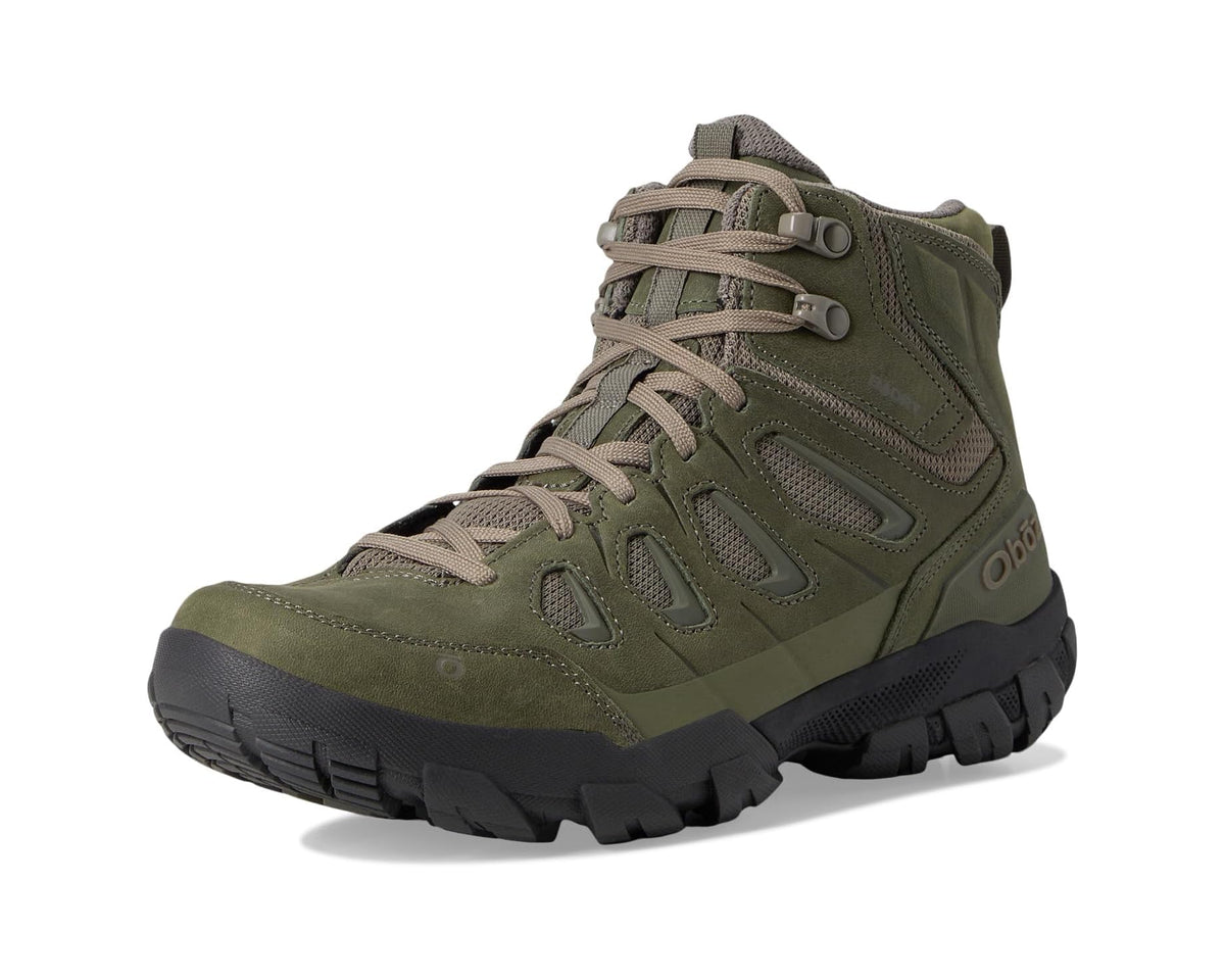 Olive green mid-top hiking boot front view, lace-up system and rugged traction tread.