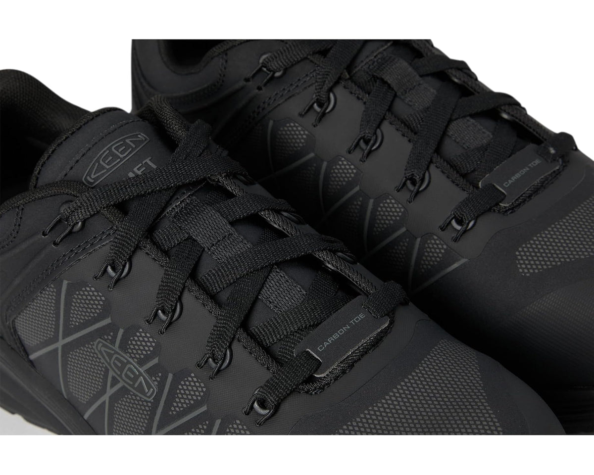Black work sneaker close-up of lace-up vamp and textured upper details