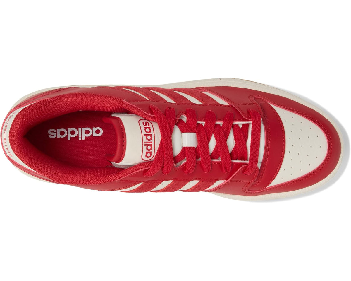 Red adidas low-top sneakers with white toe panel, three stripes, and lace-up design.