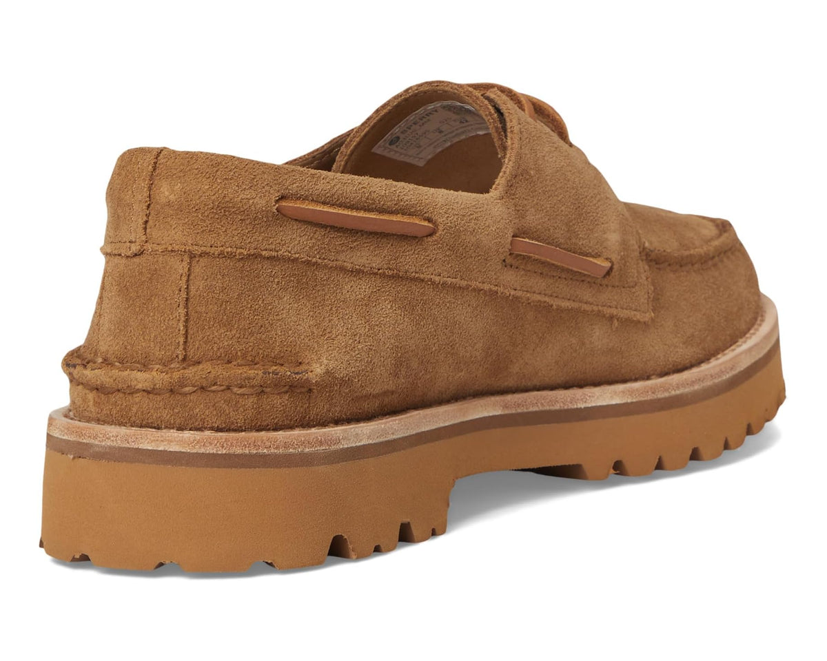 Tan suede boat shoe from heel view with slip-on collar and lug tread sole